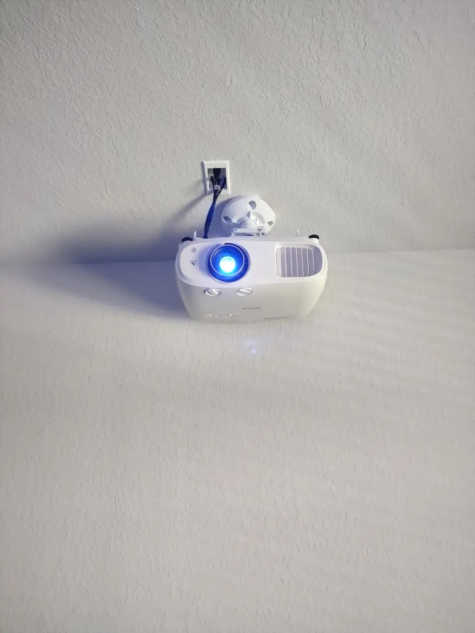 Ceiling-mounted projector on a dedicated mount with concealed cabling