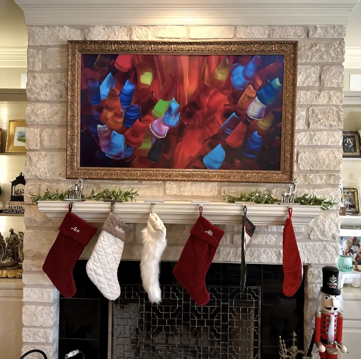 Samsung Frame TV in an ornate gold bezel displaying abstract art above an Austin stone fireplace