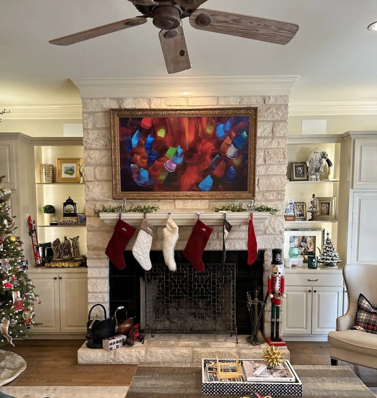 Samsung Frame TV in a gold bezel in art mode on limestone, flanked by lit built-in shelves