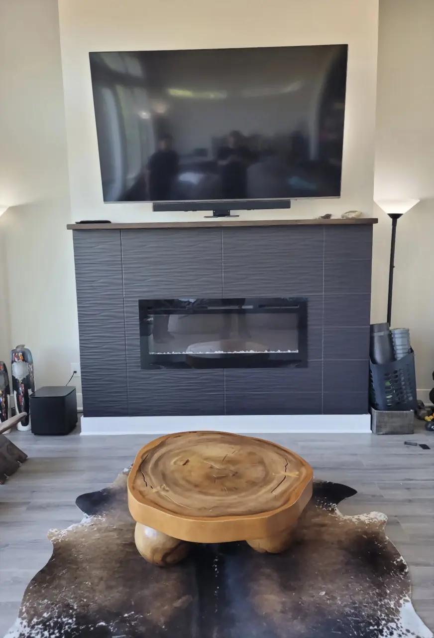 TV tucked up above a dark tile fireplace on a mantel mount