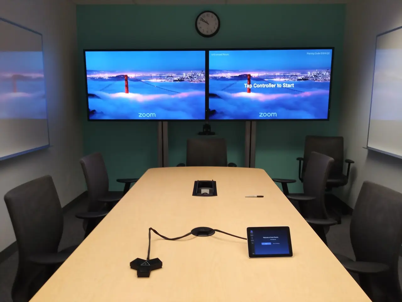 Conference room with dual wall displays, tabletop microphone and tablet controller installed